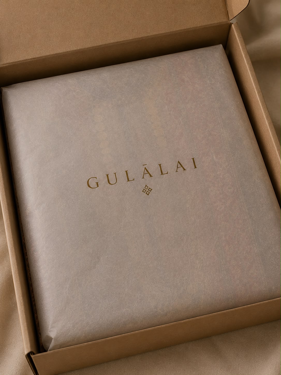 Gulālai signature tissue with a hand-tied ribbon and wax seal